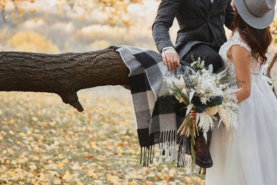 Rear view of woman holding bouquet