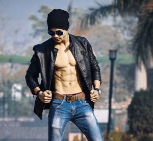 Portrait of young woman wearing sunglasses standing outdoors