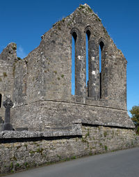 Low angle view of old building against clear blue sky