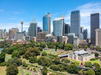 View of cityscape against blue sky during sunny day