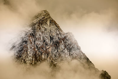 Aerial view of snowcapped mountains against sky