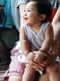 Portrait of mother with baby sitting at home