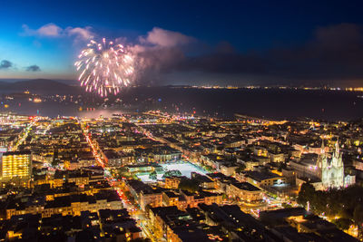 Aerial view of illuminated city against sky at night