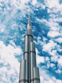 Low angle view of modern building against cloudy sky