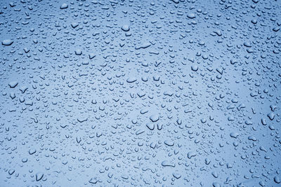 Close up rain drop on surface of car's body after passed from rainy area