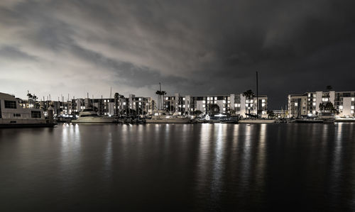 Boats moored in harbor at night