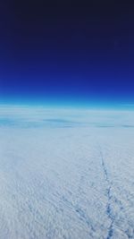 Scenic view of snow covered landscape against blue sky