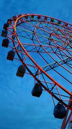 Low angle view of ferris wheel against blue sky