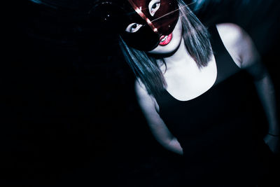 Portrait of woman in eye mask at nightclub