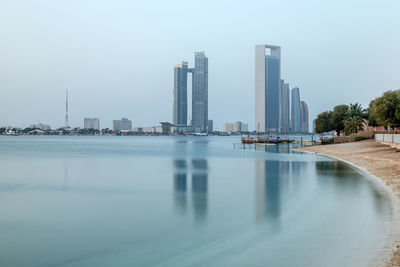 Abu dhabi skyline at sunrise. establishing shot.