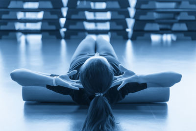 Rear view of woman exercising in gym