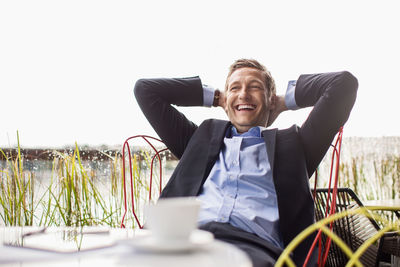 Happy man looking away while sitting in container