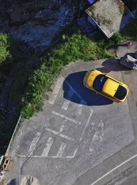 High angle view of yellow car on road
