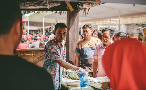 People standing at market stall