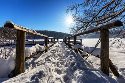 Snow covered field against sky