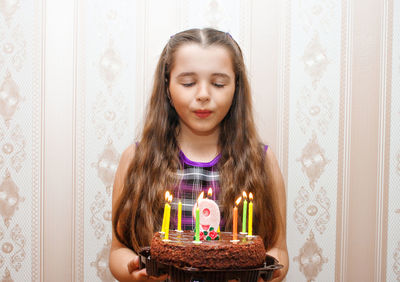 Close-up of girl blowing candles