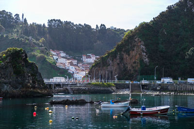 Boats in sea against sky