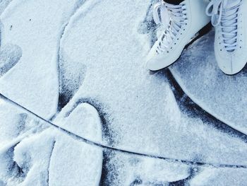 Close-up of ice skates and ice