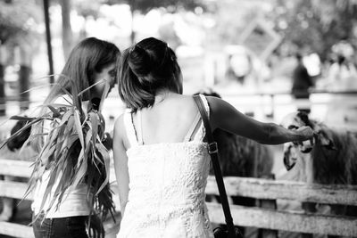 Rear view of women walking on street