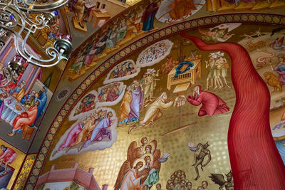 Low angle view of sculptures on ceiling of building