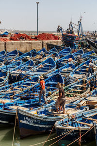 High angle view of boats moored at harbor against sky