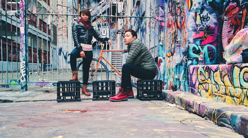 Woman standing in graffiti