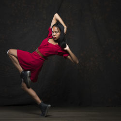 Full length of young woman dancing