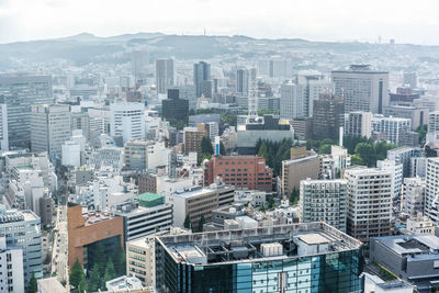 High angle view of modern buildings in city against sky