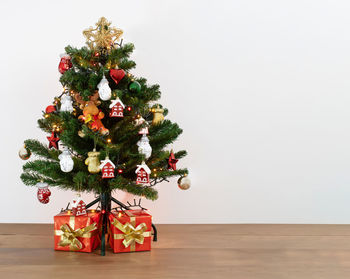 Christmas tree on floor against wall