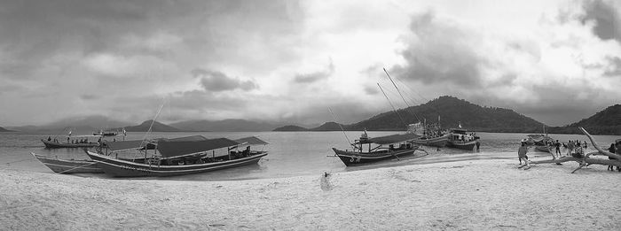 Panoramic view of fishing boats moored on sea