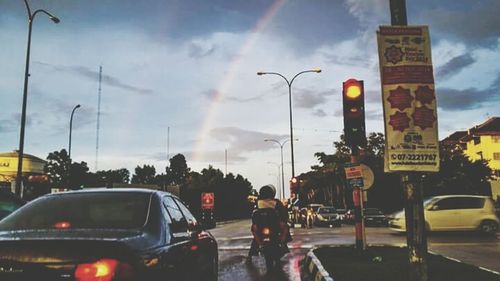 Traffic on road at sunset