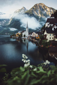 Scenic view of raw house against mountains during foggy weather