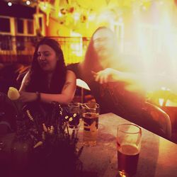 Woman sitting at restaurant table in city