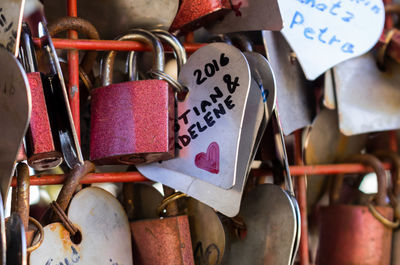 Close-up of love locks on metal grate