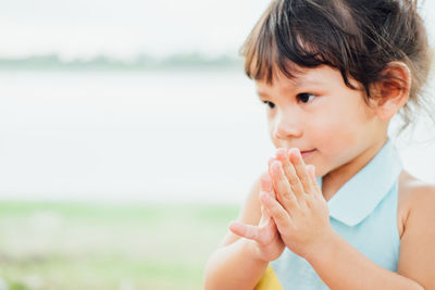 Portrait of cute boy looking away outdoors