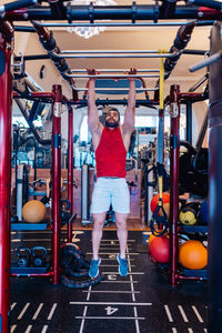 Portrait of young woman exercising in gym