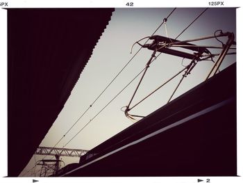 Low angle view of power lines against sky