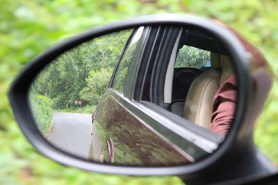 Close-up of side-view mirror of car