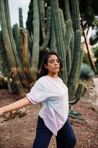 Portrait of woman standing by tree