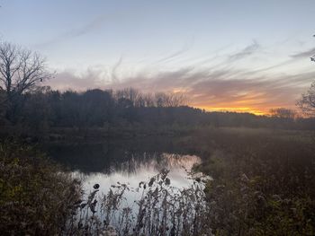 Scenic view of lake against sky during sunset