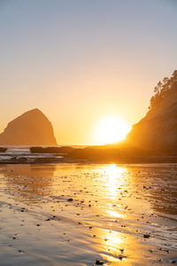 Scenic view of sea against clear sky during sunset