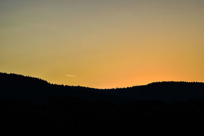 Silhouette of mountain against clear sky at sunset