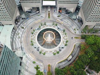 Aerial view of fountain amidst modern buildings in city