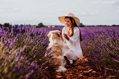 Woman with dog on lavender field