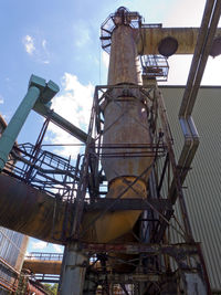 Low angle view of crane against sky