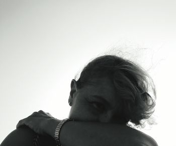 Portrait of woman looking against sky