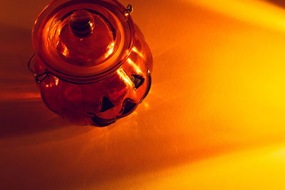 Close-up of illuminated lamp on table