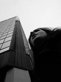 Low angle view of child against clear sky