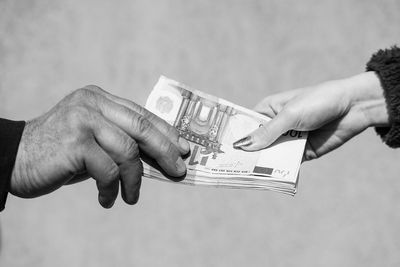 Cropped hand holding paper currency