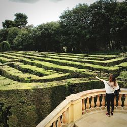 Rear view of woman standing in garden